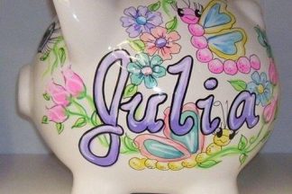 Ceramic piggy bank with flower design and the name Julia hand painted on it