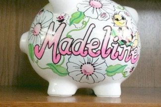 A piggy bank with the name Madeline on it.
